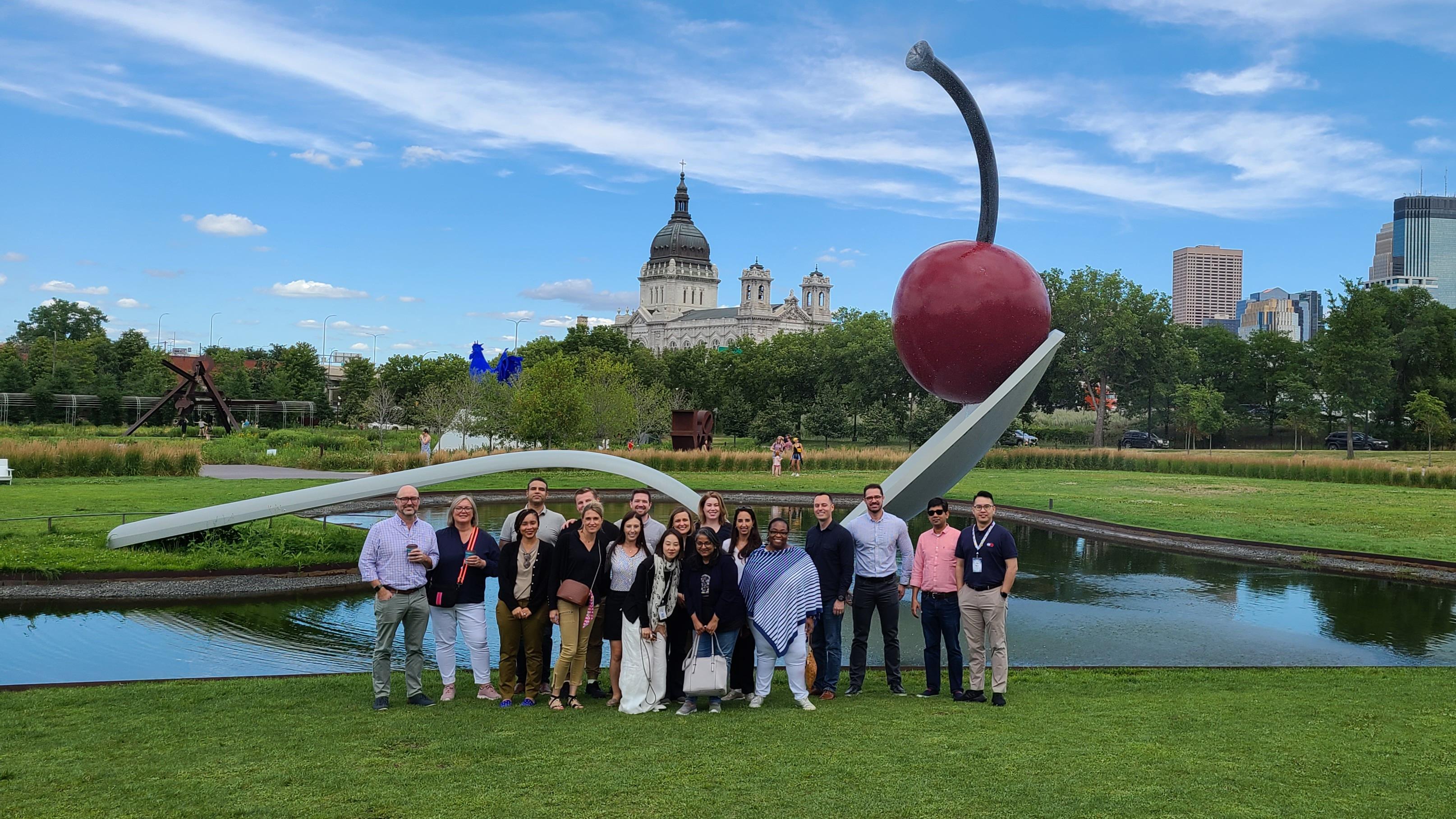 International team posing in front of the red cherry and spoon in Minneapolis